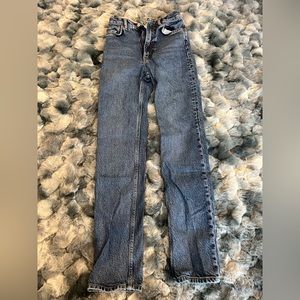 Straight leg medium-dark wash jeans. High waisted